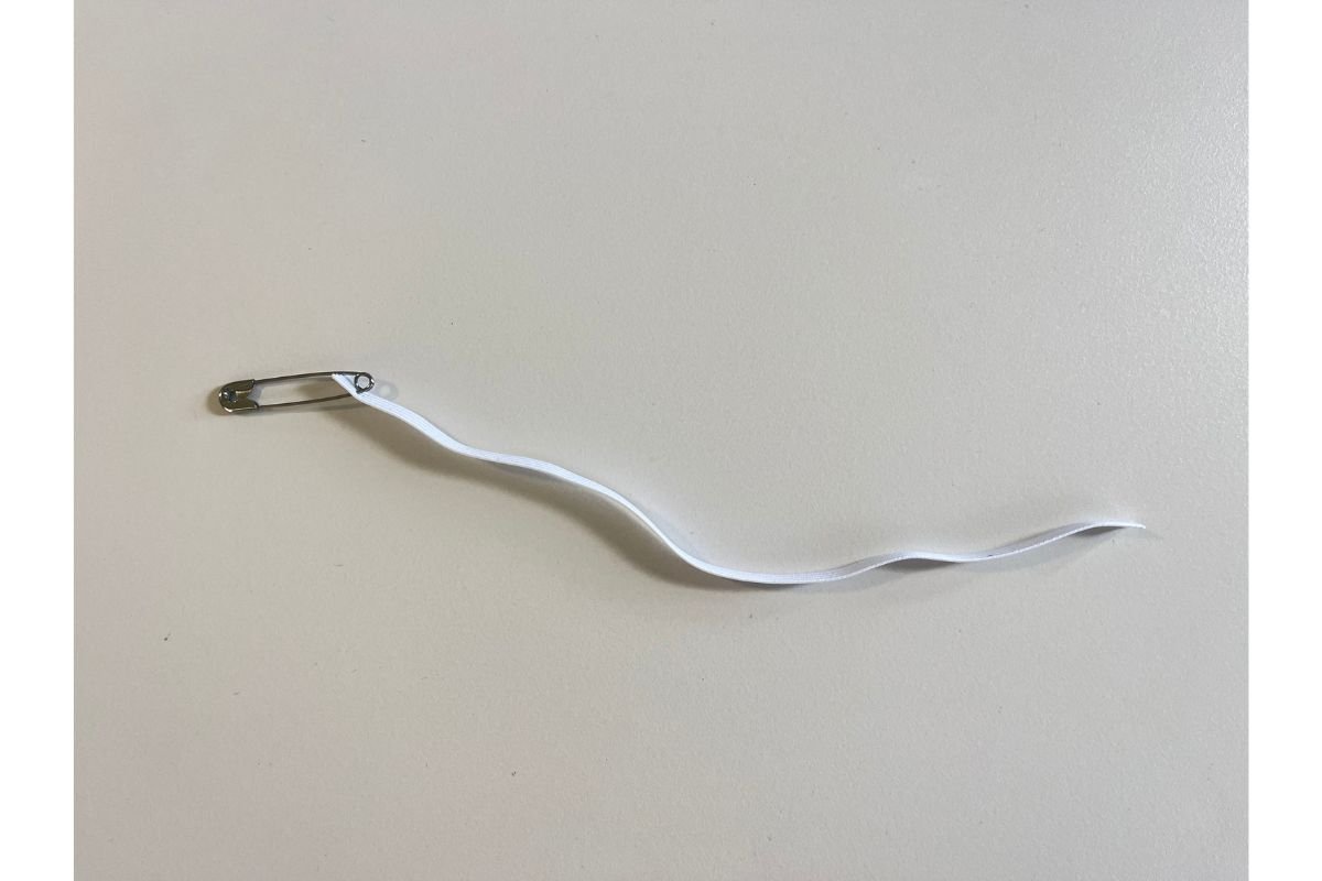 Attach the safety pin to the elastic